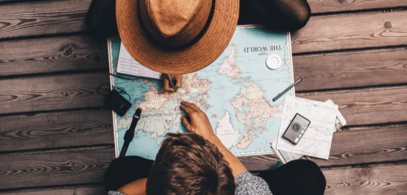 Couple plotting travel itinerary on a map.